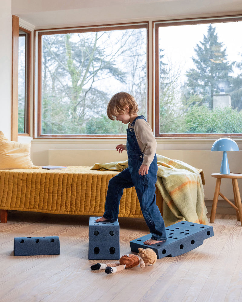 Toddler playing on indoor MODU obstacle course, built from Dreamer Set in the colour Deep Blue Sky Blue.