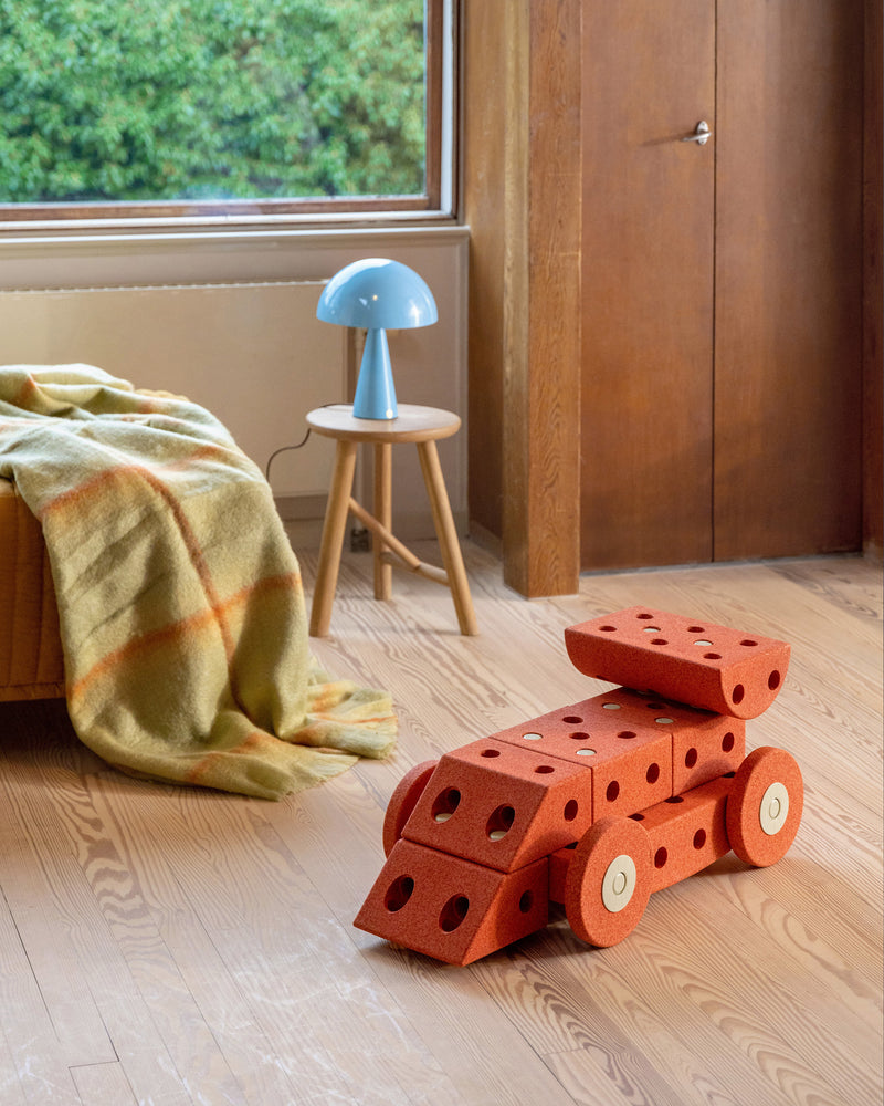 MODU racecar ride on toy styled in kids room. Built from Dreamer Set in Burnt Orange Dusty Green.