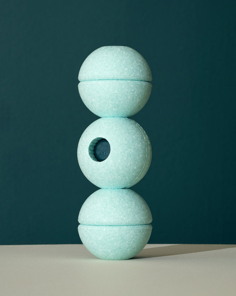 Three ocean mint MODU Foam Balls stacked vertically into a tower, demonstrating creative construction with the building toy.