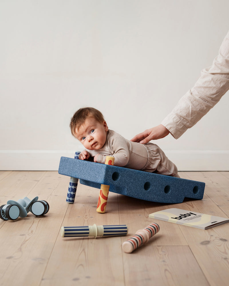A baby practices tummy time on incline
built from the MODU Baby Activity Set.