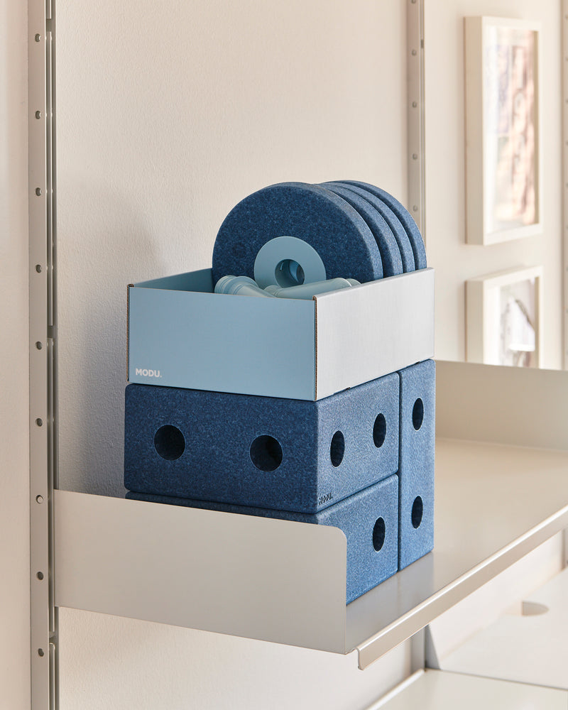 Components of the MODU 3-i-1 Baby Walker in deep blue sky blue stored neatly on a shelf.