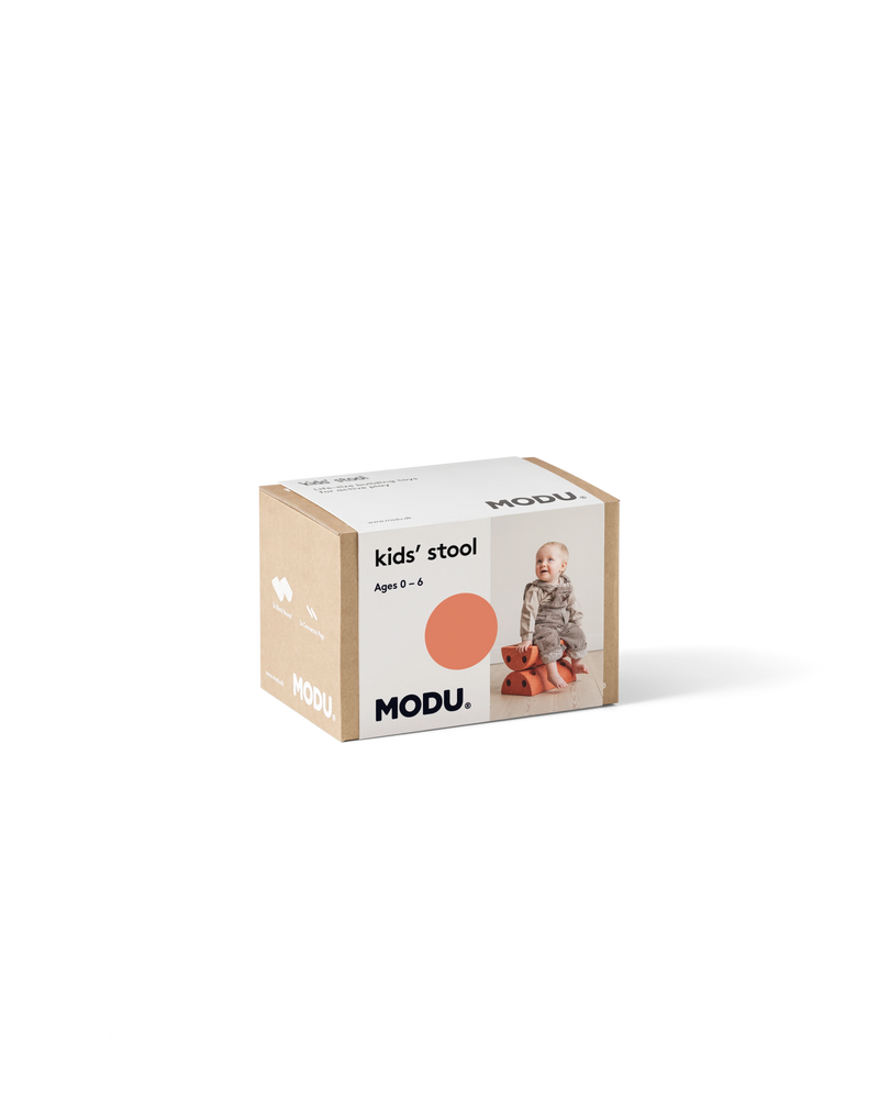 Product packaging for the burnt orange MODU Kids' Stool.