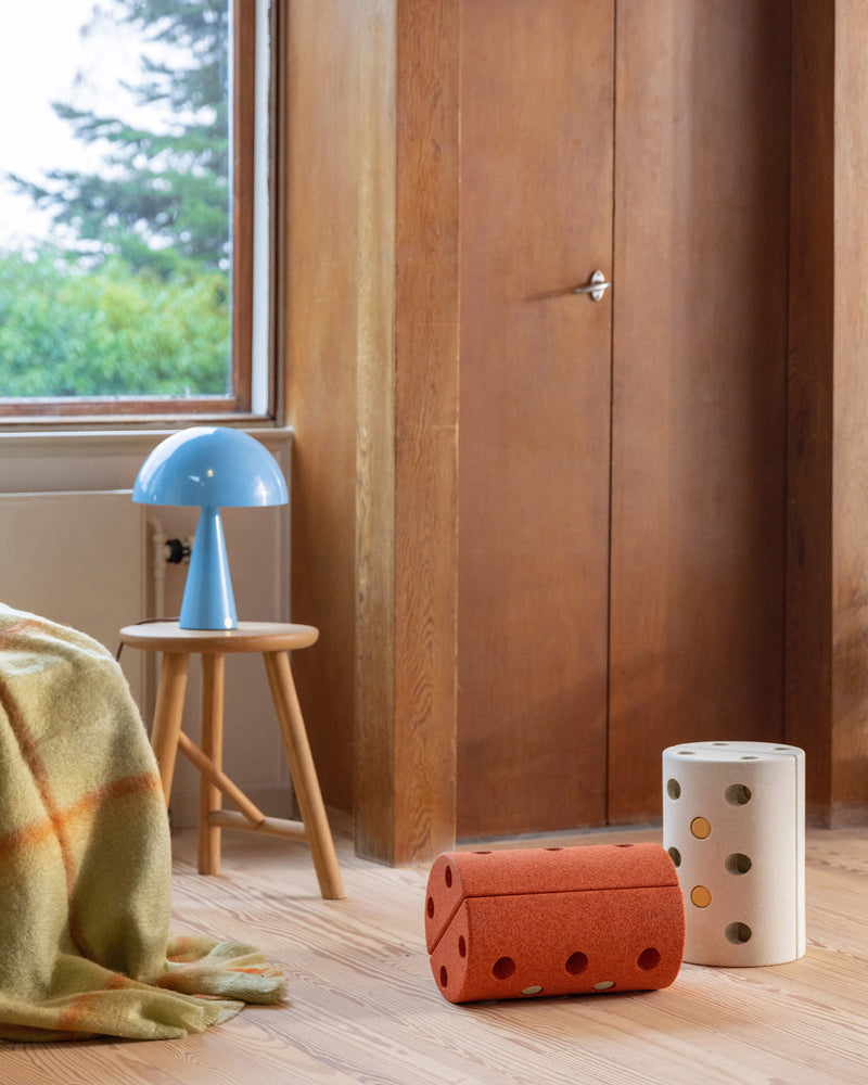 Burnt orange and sand grey MODU Kids’ Stool set on a living room floor in a modern home.
