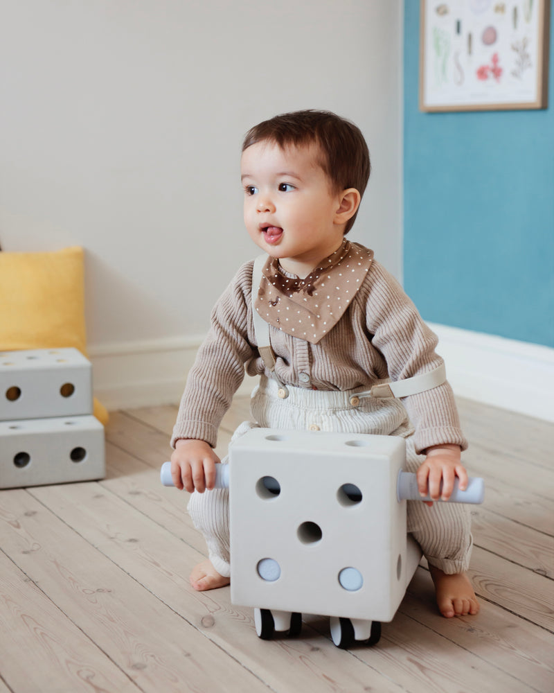 A boy on a MODU ride-on toy