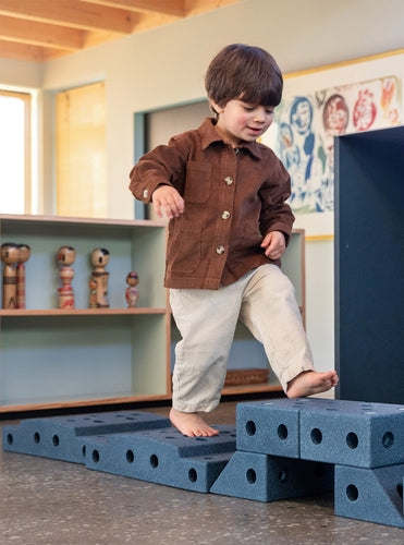 Young toddler playing on a MODU obstacle course. Product color: Deep Blue Sky Blue.