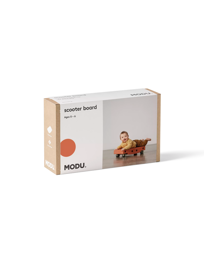 Product packaging for the burnt orange MODU Scooter Board activity toy.