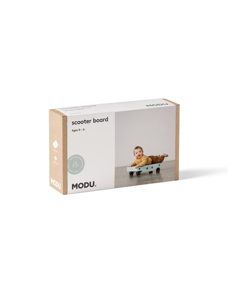 Product packaging for the ocean mint MODU Scooter Board, an open-ended modular toy designed for ages 0 to 6.