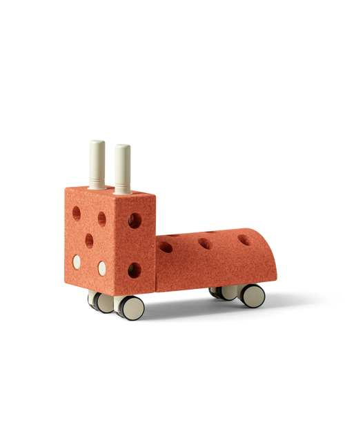 MODU Tiny Ride, ride-on toy for babies and toddlers, in the color Burnt Orange Dusty Green.